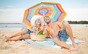 Smiling couple sunbathing on the beach