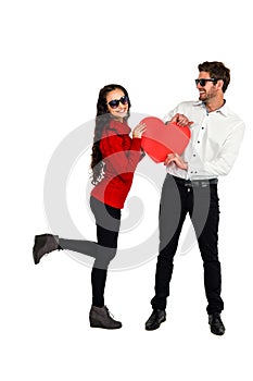 Smiling couple with sunglasses holding paper heart