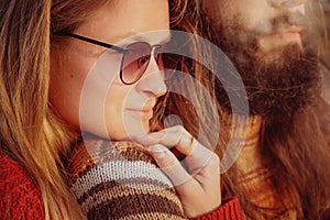 Smiling couple in sunglasses hugging and having fun outdoors in