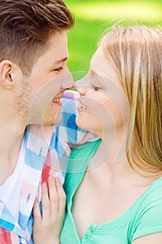 Smiling couple touching noses in park