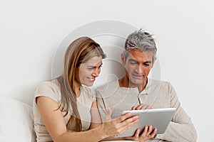 Smiling couple using the ipad photo