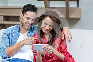 Smiling couple using smartphone