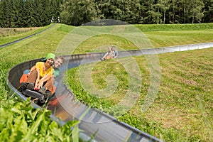 Smiling Couples Enjoying Summer Sledge