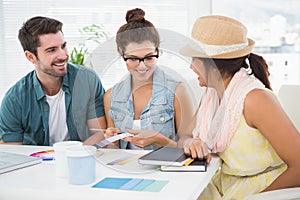 Smiling coworkers using colour wheel