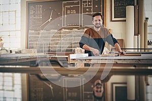 Smiling craftsman at work in his woodwork studio
