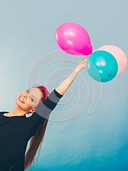 Smiling crazy girl having fun with balloons.