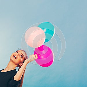 Smiling crazy girl having fun with balloons.