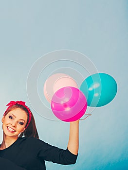 Smiling crazy girl having fun with balloons.