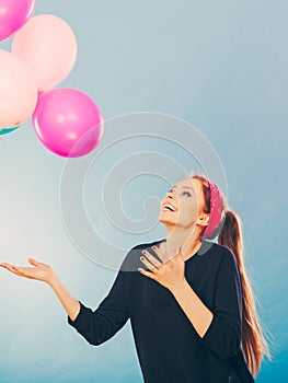 Smiling crazy girl having fun with balloons.