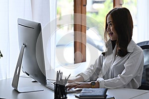 Creative woman working with computer at modern office.