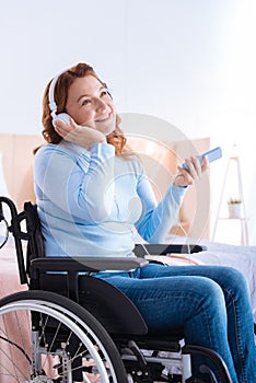 Smiling crippled woman doing her favourite activity