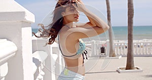 Smiling curvaceous young woman at the seaside