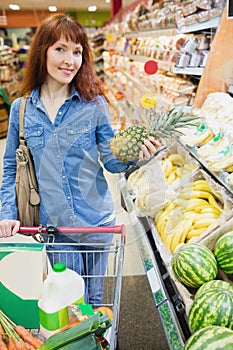Smiling customer holding a pineapple