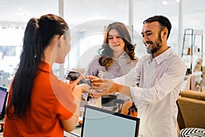 smiling customer man using EDC device while making payment at the checkout