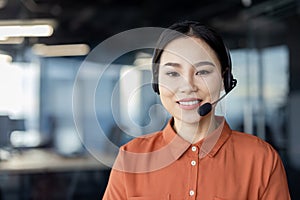 Smiling customer service representative with headset in modern office environment