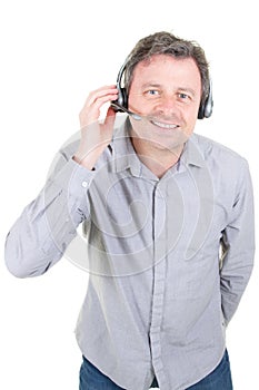 Smiling customer support phone operator man in call center in white background