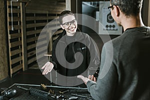 smiling customer talking with shooting instructor