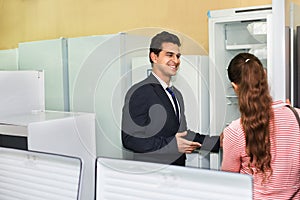Smiling customers looking at large fridges