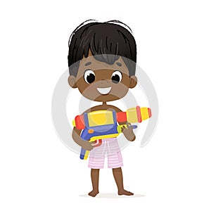 Smiling Cute African-American Baby Boy With a Toy Water Gun Posing. Pool Party Character with a Toygun. Beach Dark Skin photo
