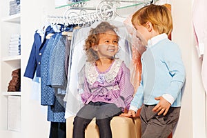 Smiling cute boy looks at girl while shopping