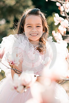 Smiling cute child girl with flowers outdoor