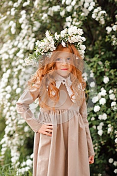 Smiling cute child girl with flowers outdoor