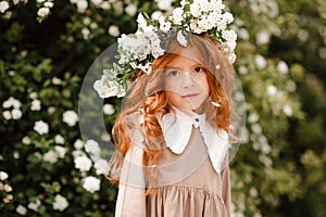 Smiling cute child girl with flowers outdoor