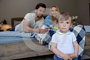 Smiling cute family on the bed looking contented