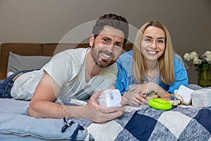 Smiling cute family on the bed looking contented