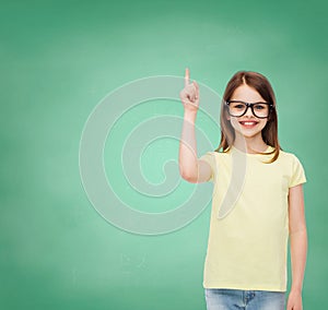 Smiling cute little girl in black eyeglasses