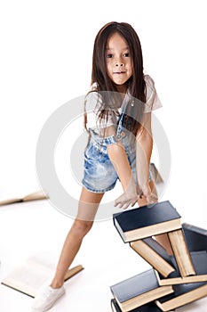 Cute little girl is reading a book.