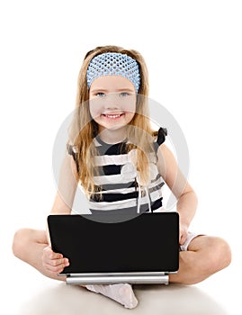 Smiling cute little girl with laptop