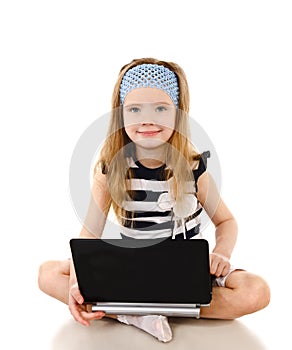 Smiling cute little girl with laptop isolated