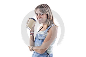 Smiling cute young girl holding a take away coffee while looking at camera isolated on white background