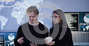 Smiling cyber security team working in a Cyber Security Operations Center SOC to protect systems and technologies