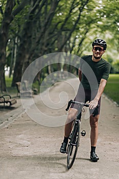 Smiling cyclist resting after morning ride outdoors