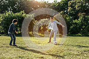 Smiling daddy and boy playing football