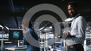 Smiling data center engineering team on industrial platform