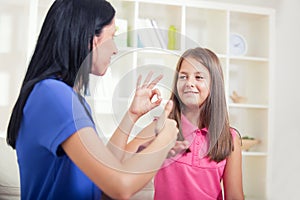 Smiling deaf girl learning sign language