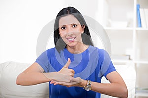 Smiling deaf woman using sign language