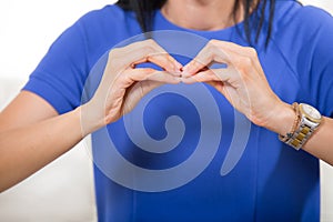 Smiling deaf woman using sign language