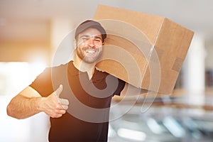 Smiling delivery man with box