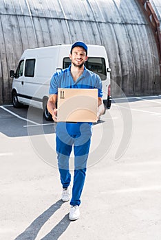 Delivery man with cardboard box