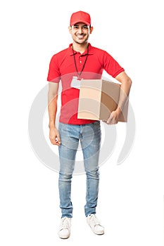 Smiling Delivery Man Carrying Cardboard Box