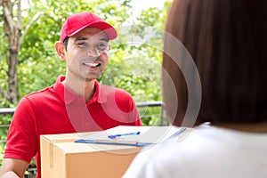 Smiling delivery man delivering parcel to a woman
