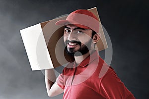 Smiling delivery man hold cardboard box