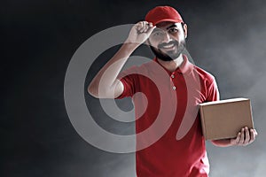 Smiling delivery man hold cardboard box