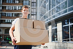 Smiling delivery man holding a paper box
