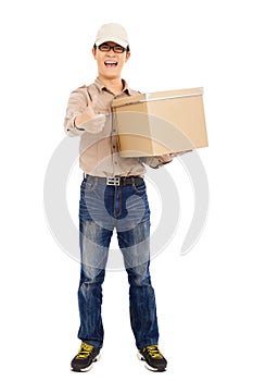 Smiling delivery man holding parcel and thumb up