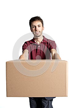 Smiling delivery man holding pile of cardboard boxes on a white background